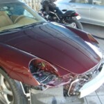 Before and after photographs of a damaged Porsche that was repaired by Elite Paint & Body Shop in West Palm Beach, Florida.